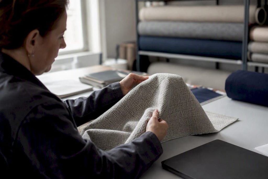 Hands inspecting fabric texture in laundry