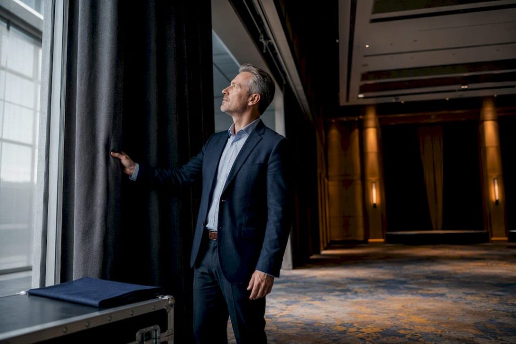Facility manager inspecting acoustic curtain track
